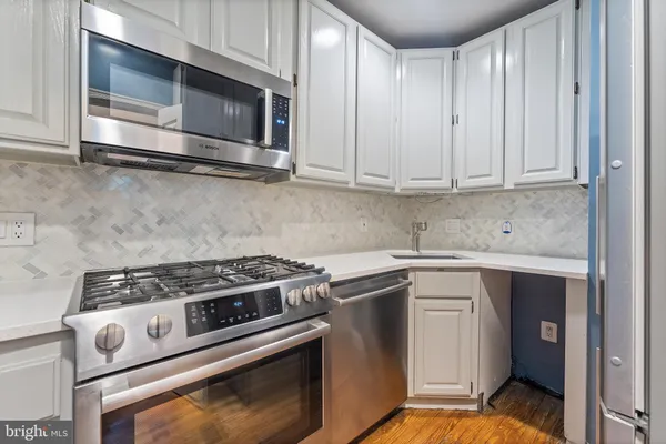 a kitchen with microwave cabinets and stainless steel appliances