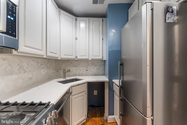 a kitchen with a sink and cabinets