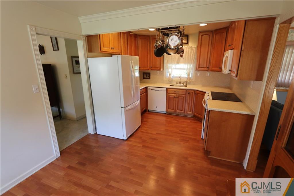20 Flower Road Somerset, NJ 08873 - Photo 4 of 25 a kitchen with refrigerator a microwave and furniture