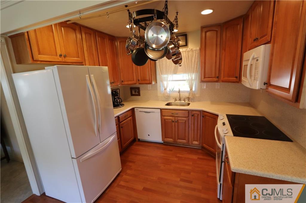 20 Flower Road Somerset, NJ 08873 - Photo 5 of 25 a kitchen with a sink a refrigerator and cabinets