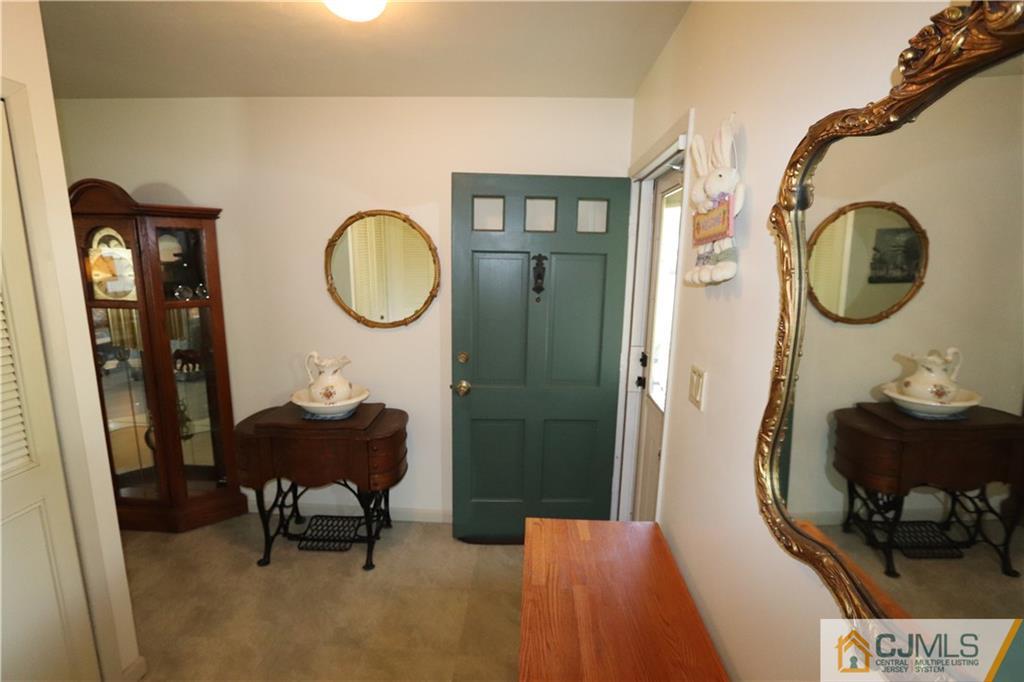 20 Flower Road Somerset, NJ 08873 - Photo 9 of 25 a living room with furniture and a mirror
