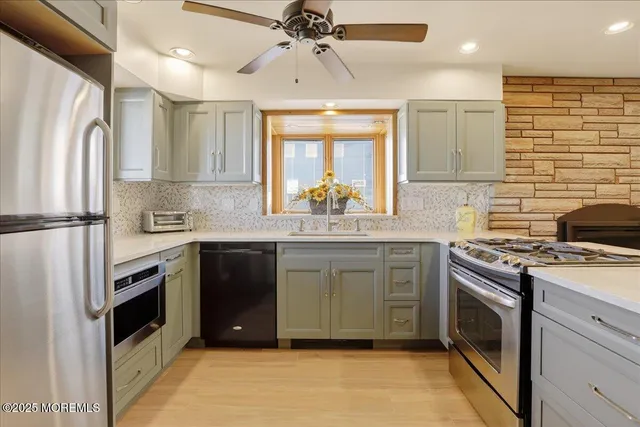 a kitchen with stainless steel appliances granite countertop a stove a sink and a refrigerator