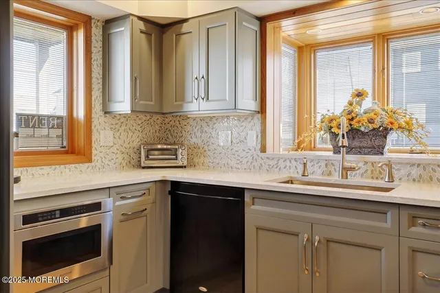 a kitchen with stainless steel appliances granite countertop a sink and a stove