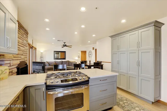 a kitchen with stove cabinets and refrigerator