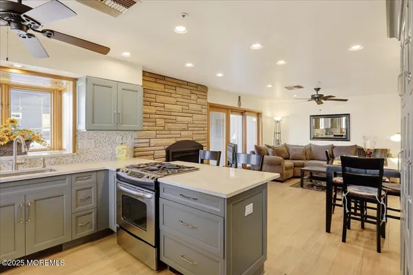 a open kitchen with kitchen island a sink table and chairs