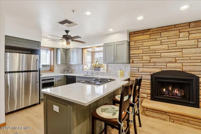 a kitchen with a table chairs refrigerator and cabinets