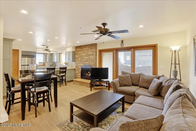a living room with furniture a flat screen tv and a large window