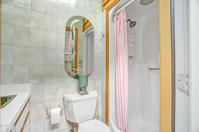 a bathroom with a toilet and a shower