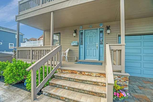 a view of entryway with wooden floor and front door