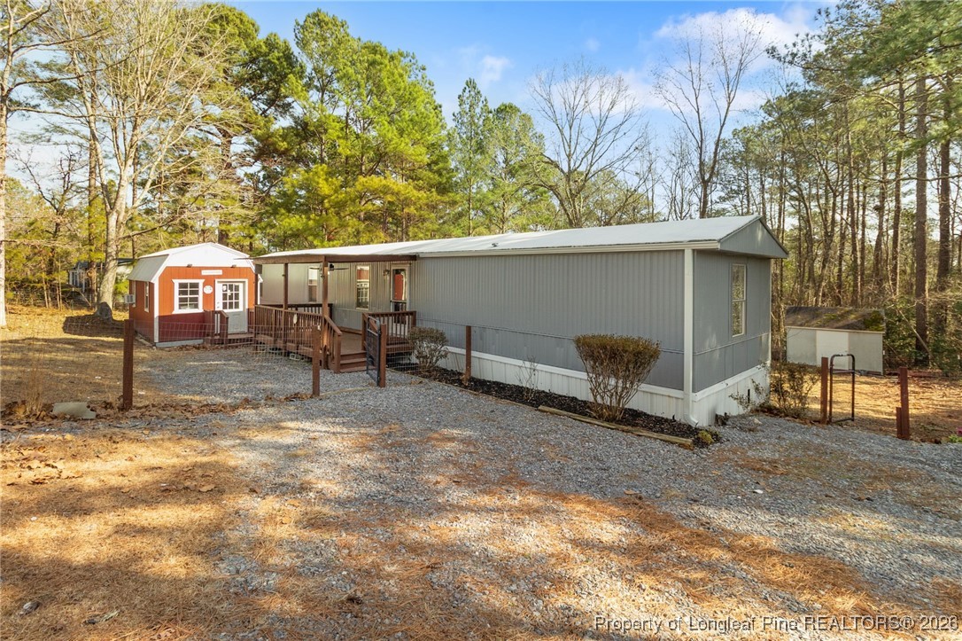 a backyard of a house with barbeque oven table and chairs