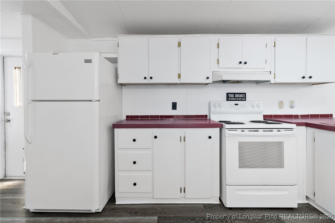 7321 Sheriff Watson Road Sanford, NC 27332 - Photo 11 of 26 a kitchen with white cabinets and white appliances