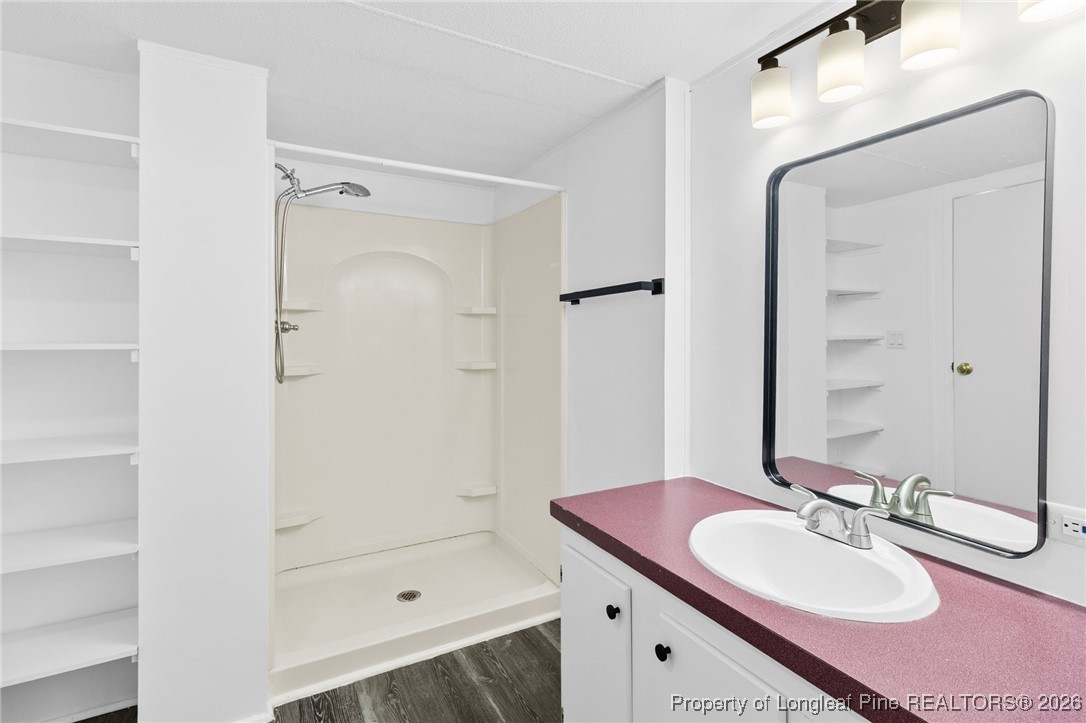 7321 Sheriff Watson Road Sanford, NC 27332 - Photo 16 of 26 a bathroom with a sink a toilet and shower