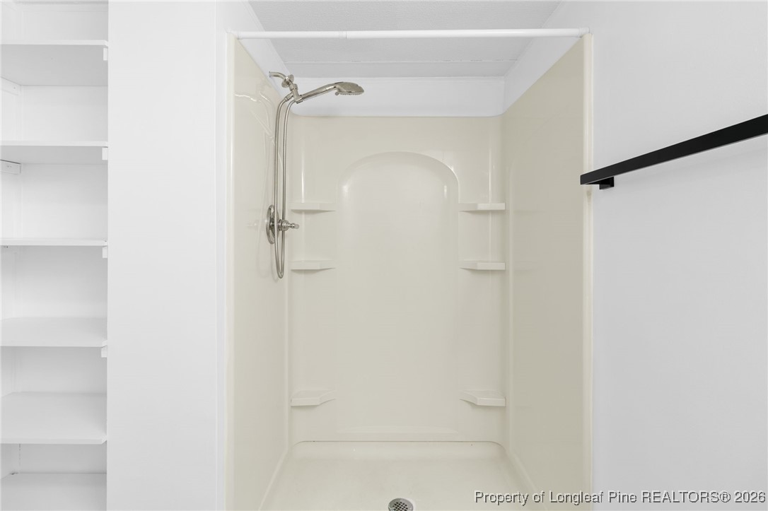 7321 Sheriff Watson Road Sanford, NC 27332 - Photo 17 of 26 a bathroom with a glass shower door