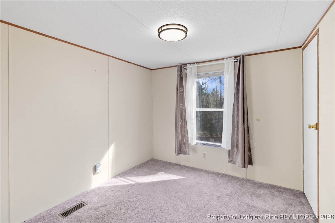 7321 Sheriff Watson Road Sanford, NC 27332 - Photo 19 of 26 a view of a room with wooden floor and windows
