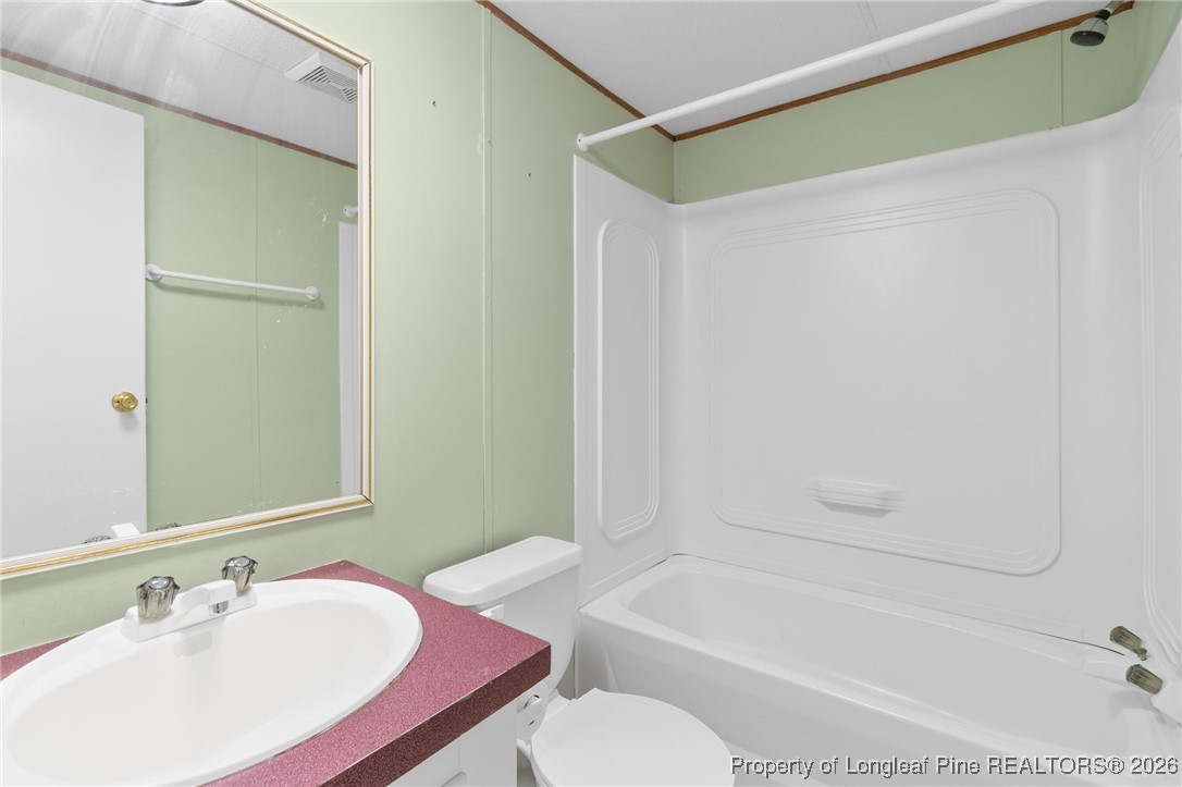 7321 Sheriff Watson Road Sanford, NC 27332 - Photo 20 of 26 a bathroom with a sink and a mirror