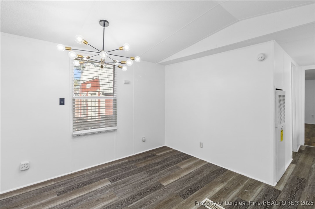 7321 Sheriff Watson Road Sanford, NC 27332 - Photo 6 of 26 a view of an empty room with wooden floor fridge and a window