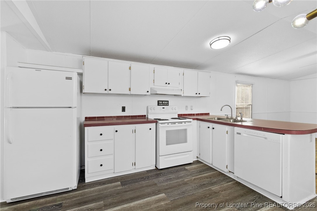 7321 Sheriff Watson Road Sanford, NC 27332 - Photo 9 of 26 a kitchen with granite countertop white cabinets and white appliances