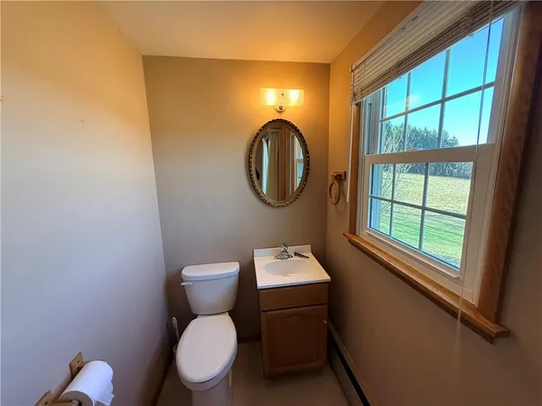 a bathroom with a toilet a sink and a window