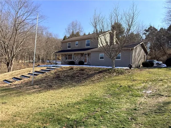 a view of a house with a yard covered with snow