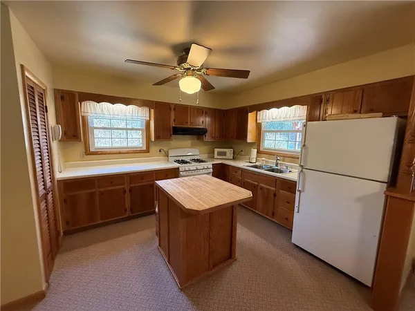 a kitchen with a refrigerator a stove a sink dishwasher and a refrigerator