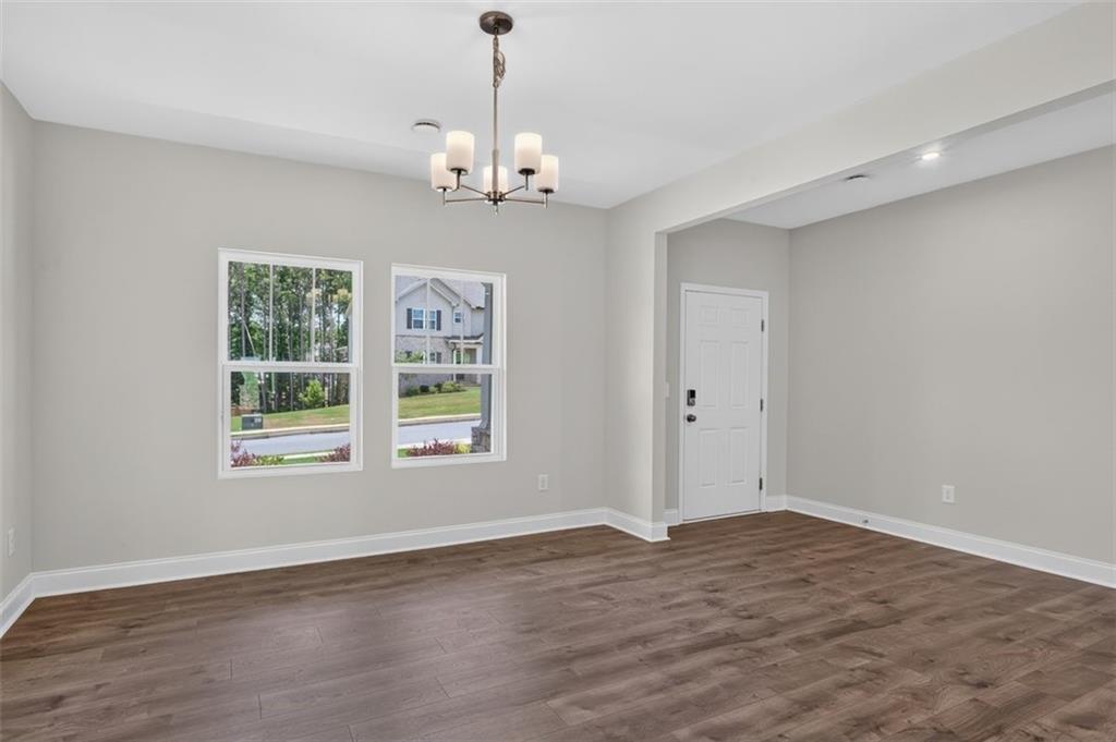107 Ledgemont Way Acworth, GA 30101 - Photo 6 of 57 a view of an empty room with wooden floor and a window
