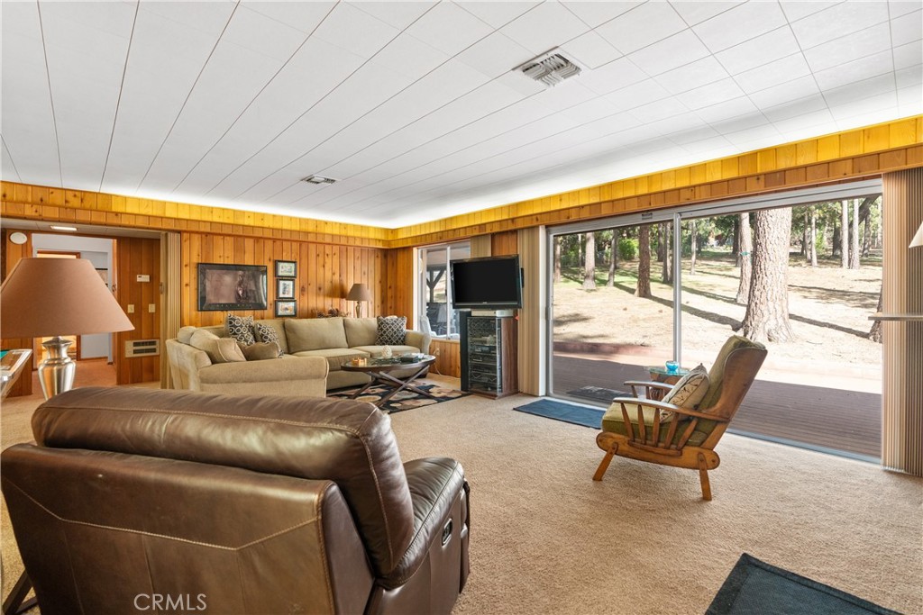 25220 Rim Rock Road Idyllwild, CA 92549 - Photo 15 of 55 a living room with furniture a large window with outer view