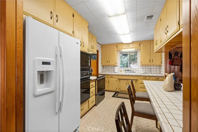 a kitchen with stainless steel appliances a refrigerator and a stove