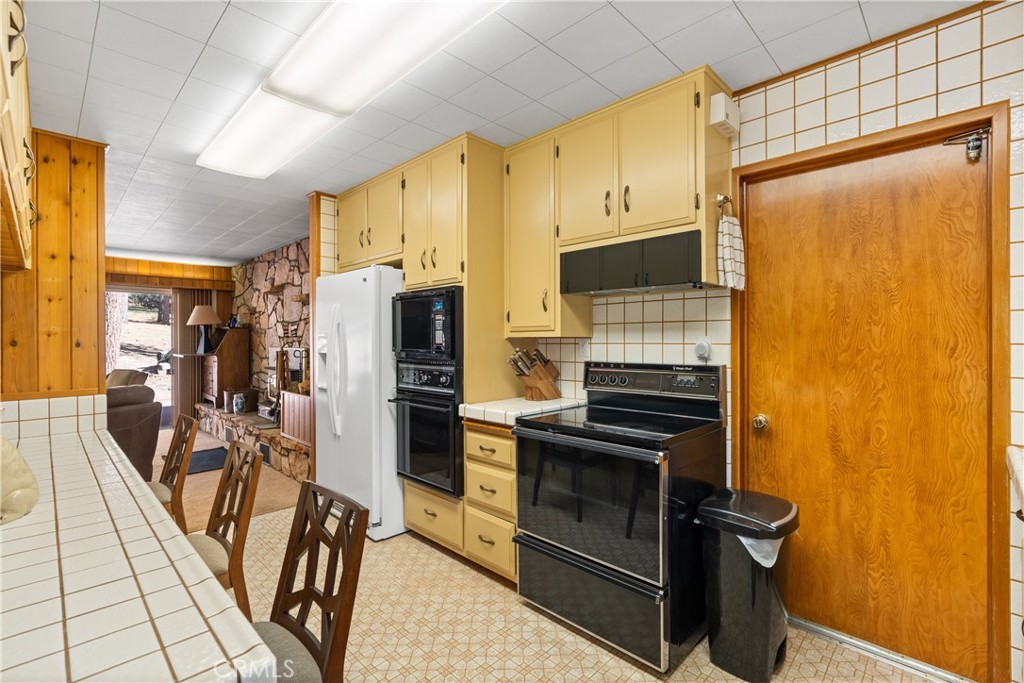 25220 Rim Rock Road Idyllwild, CA 92549 - Photo 19 of 55 a kitchen with stainless steel appliances a refrigerator and a stove