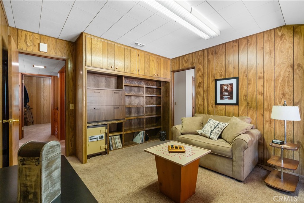 25220 Rim Rock Road Idyllwild, CA 92549 - Photo 26 of 55 a living room with furniture a flat screen tv and a table