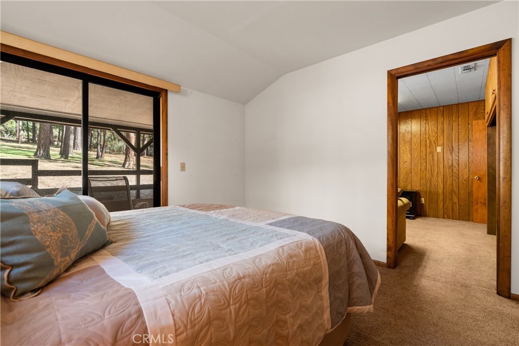 25220 Rim Rock Road Idyllwild, CA 92549 - Photo 28 of 55 a bedroom with a bed and a large window