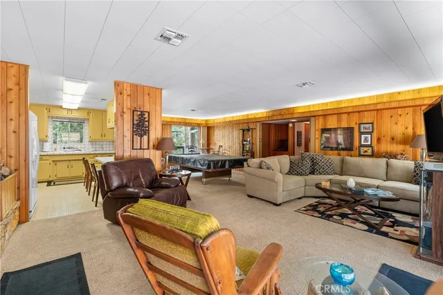 a room with chairs pool table and chairs