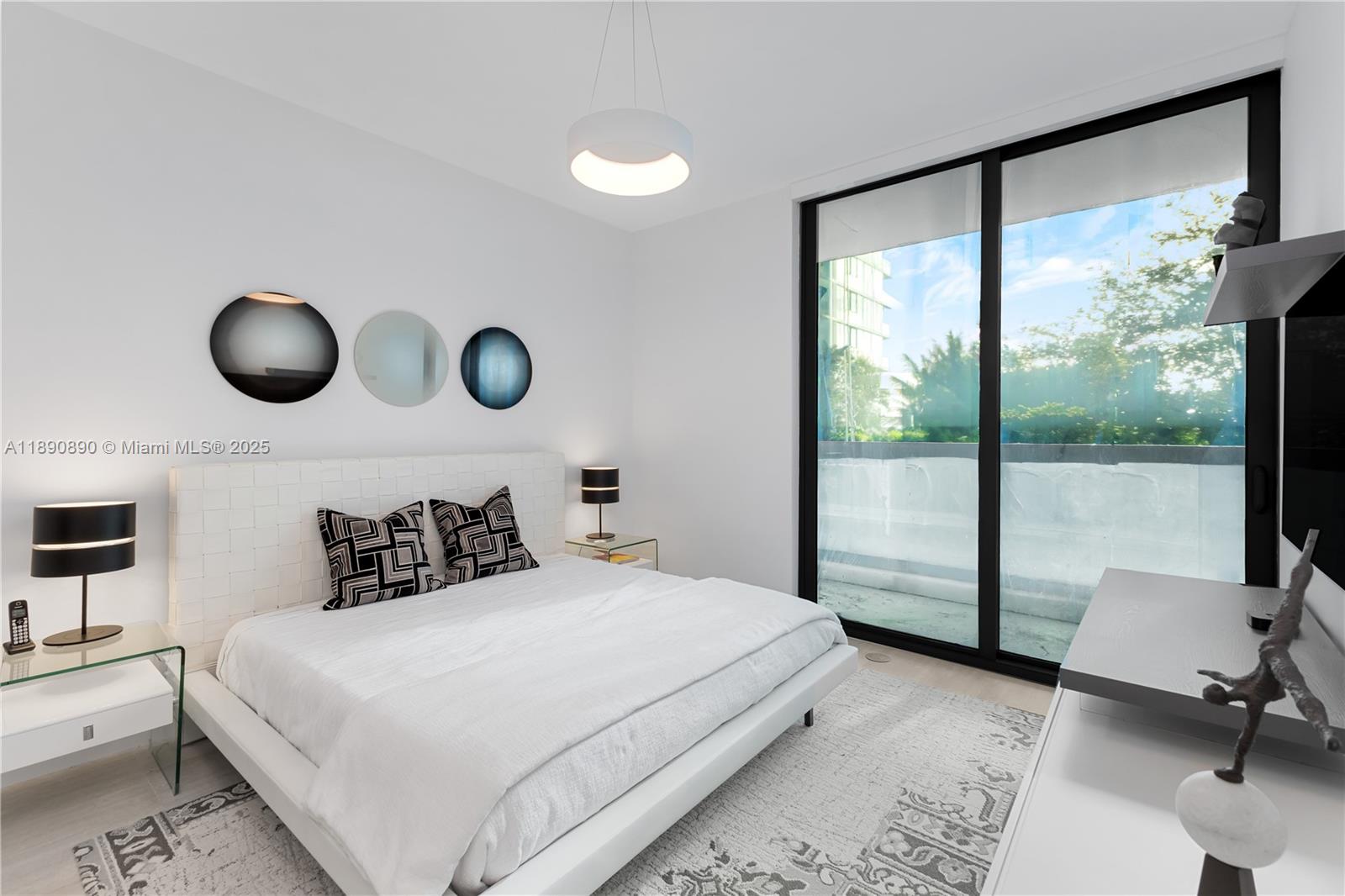 650 Northeast 32nd Street, Unit BH7 Miami, FL 33137 - Photo 17 of 53 a bedroom with a large bed and a large window