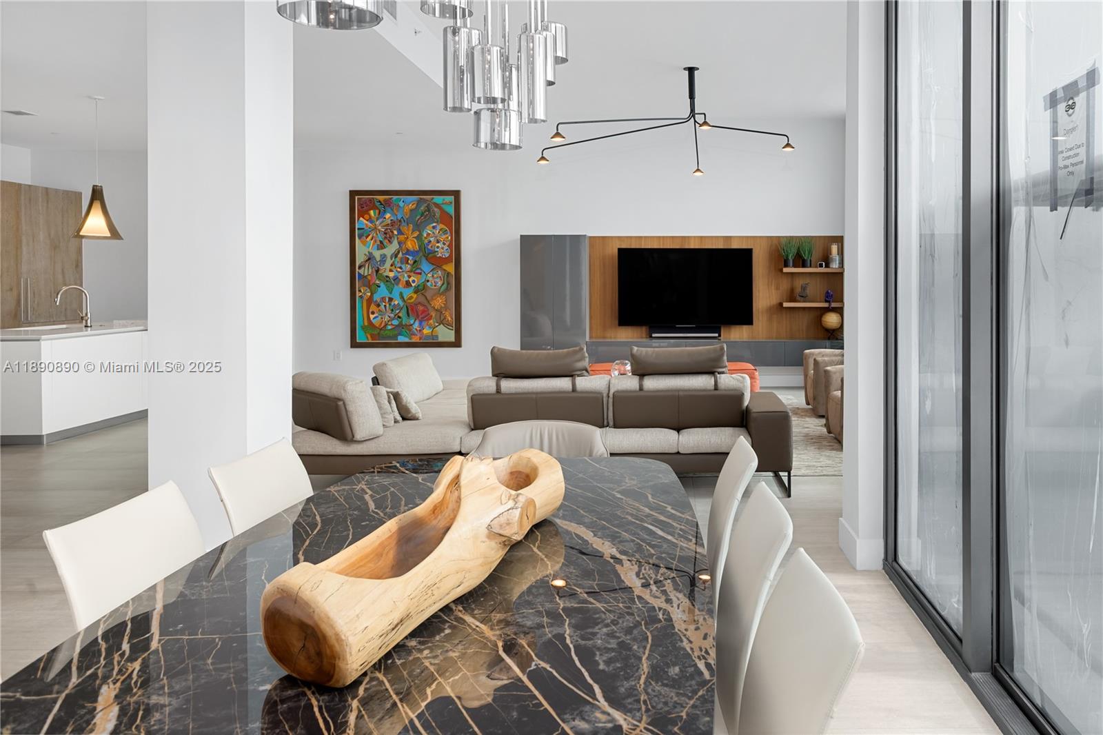 650 Northeast 32nd Street, Unit BH7 Miami, FL 33137 - Photo 50 of 53 a living room with furniture a flat screen tv and a fireplace