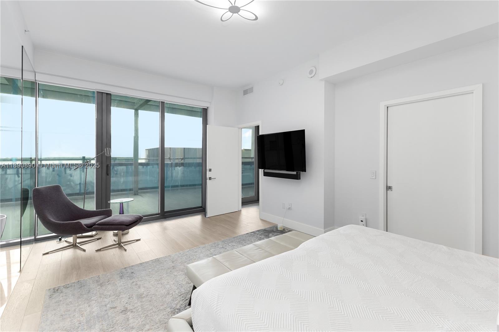 650 Northeast 32nd Street, Unit BH7 Miami, FL 33137 - Photo 10 of 53 a bedroom with a bed and glass window