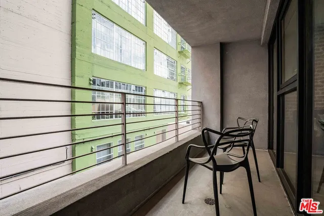 a view of a chairs and table in the balcony