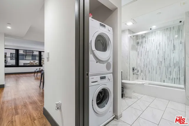a view of a hallway with washer and dryer
