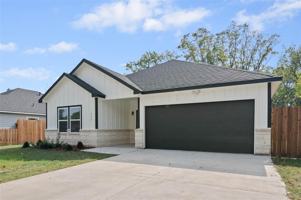 1520 Harris Street Gainesville, TX 76240 - Photo 1 of 24 a front view of a house with a yard and garage