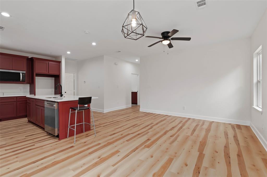 1520 Harris Street Gainesville, TX 76240 - Photo 12 of 24 a view of a room with wooden floor and staircase