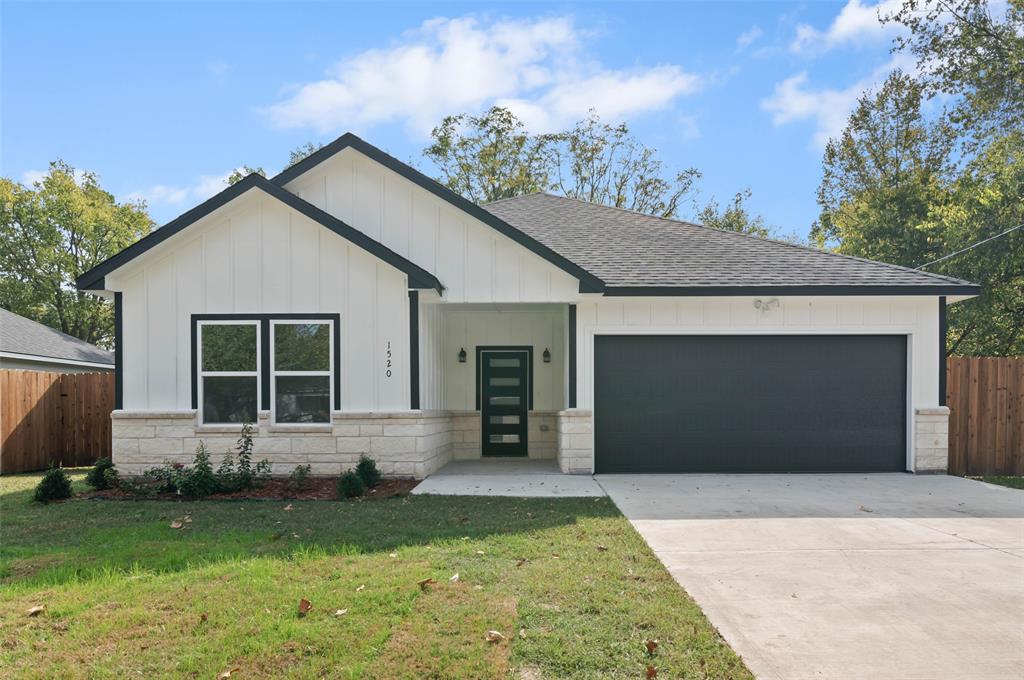 1520 Harris Street Gainesville, TX 76240 - Photo 2 of 24 front view of a house with a yard and garage