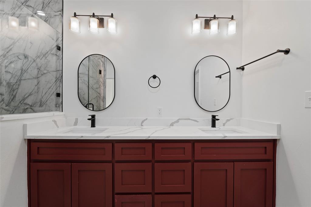 1520 Harris Street Gainesville, TX 76240 - Photo 21 of 24 a bathroom with a sink a mirror and vanity