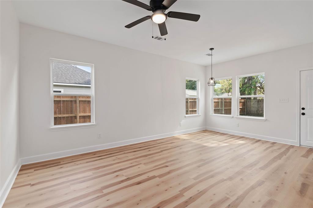 1520 Harris Street Gainesville, TX 76240 - Photo 10 of 24 a view of an empty room with wooden floor and a window