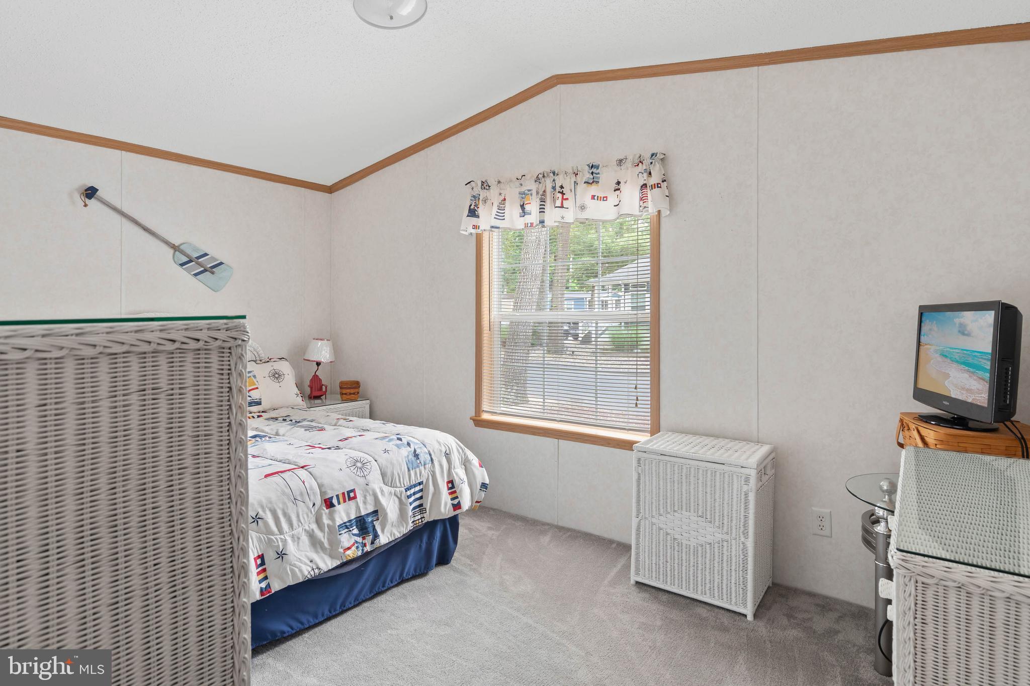 25754 Blue Ridge Street Millsboro, DE 19966 - Photo 21 of 32 a bedroom with a bed and a window