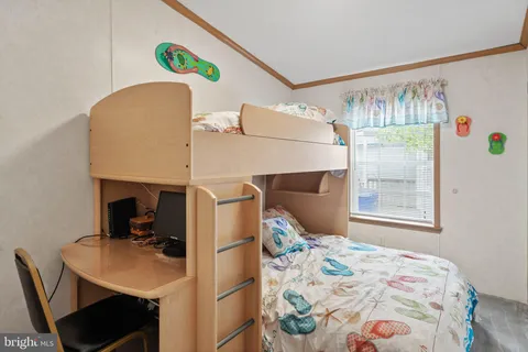 a bedroom with a bed and a table in it