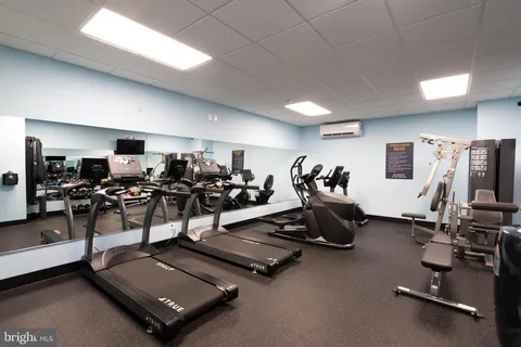 a room with gym equipment and a large window