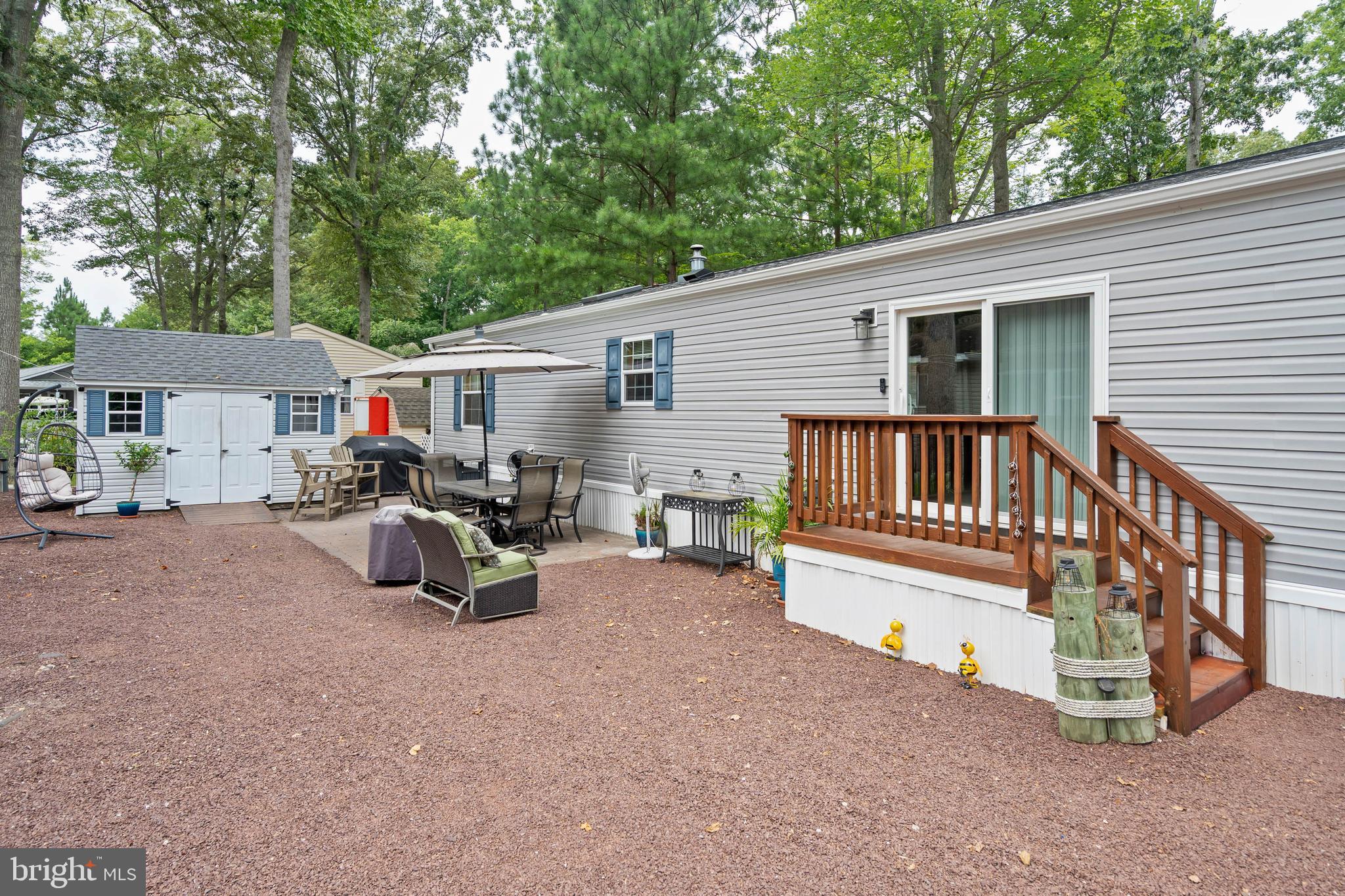 25754 Blue Ridge Street Millsboro, DE 19966 - Photo 3 of 32 a view of a house with a deck and a yard