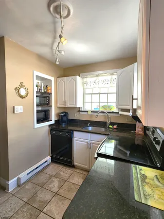 a kitchen with a refrigerator and a stove