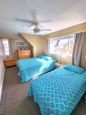 a bedroom with a bed and dresser with mirror