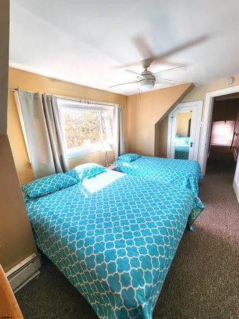 a bedroom with a bed and a mirror