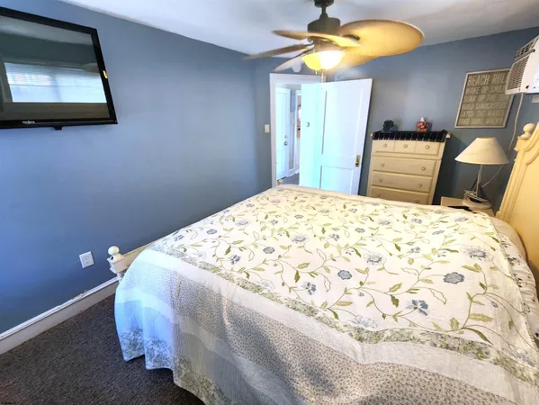 a bedroom with a bed and a mirror