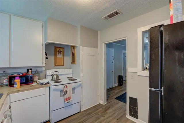 a kitchen with a refrigerator and cabinets